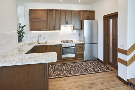 Modern wooden kitchen in scandinavian interior with cooking appliances. Real imageの写真素材