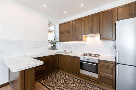 Modern wooden kitchen in scandinavian interior with cooking appliances. Real imageの写真素材
