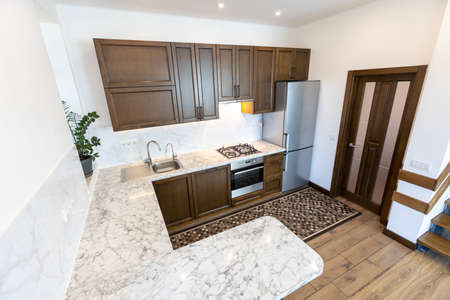 Modern wooden kitchen in scandinavian interior with cooking appliances. Real imageの写真素材