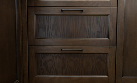 Brown wooden kitchen shelf with black handelsの写真素材