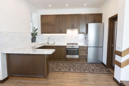 Modern wooden kitchen in scandinavian interior with cooking appliances. Real imageの写真素材