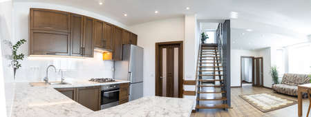 Modern wooden kitchen in scandinavian interior with cooking appliances. Real imageの写真素材