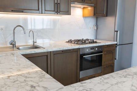 Modern wooden kitchen in scandinavian interior with cooking appliances. Real imageの写真素材