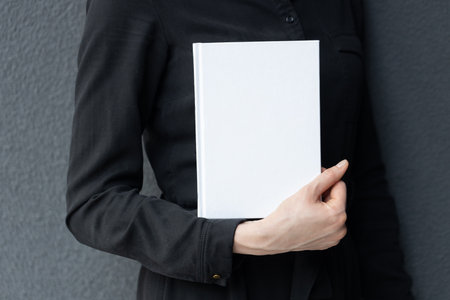 White book cover in woman's hands. Book cover for mock upの写真素材
