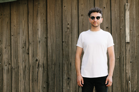 Hipster handsome male model wearing white blank t-shirt with space for your or design in casual urban styleの写真素材