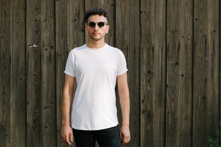 Hipster handsome male model wearing white blank t-shirt with space for your or design in casual urban styleの写真素材