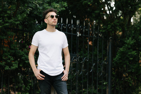 Hipster handsome male model wearing white blank t-shirt with space for your or design in casual urban styleの写真素材