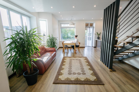 Woman working in modern private home interiorの写真素材