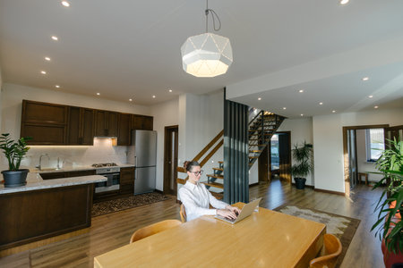 Woman working in modern private home interiorの写真素材