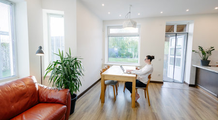 Woman working in modern private home interiorの写真素材