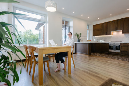 Woman working in modern private home interiorの写真素材