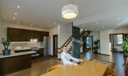 Woman working in modern private home interiorの写真素材