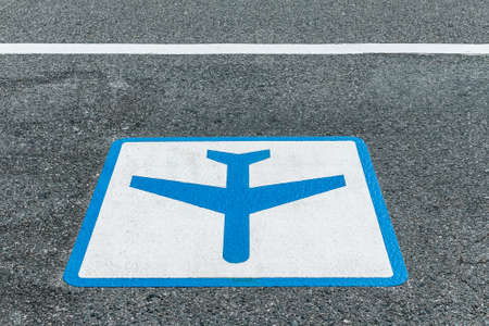 sign painted on asphalt road for airport shuttle bus