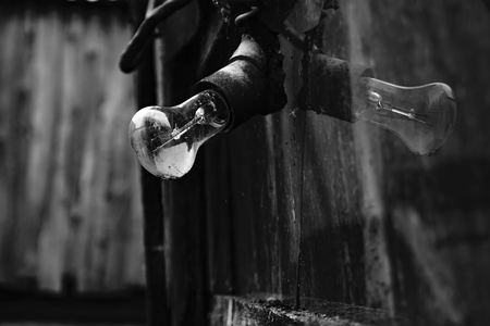Old light bulb with reflection in broken glass