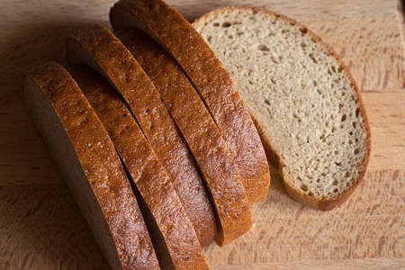 sliced rye bread on a wooden board closeup