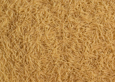 Scattered uncooked, dry vermicelli texture background close-upの写真素材