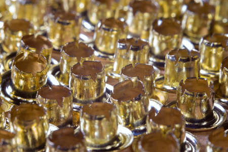 Golden eyelets lying rows, rivets loose close-upの写真素材