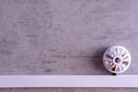 fire detector installed on a concrete gray wallの写真素材