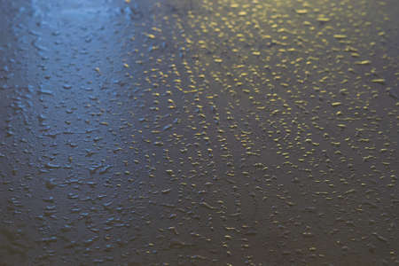 drops of water sprayed on the gray surface of the tableの写真素材