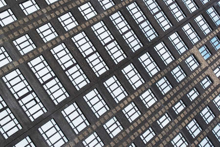 parallel lines of windows of a high-rise brick building