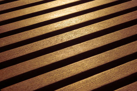 surface of brown wooden slats with sun reflectionの写真素材