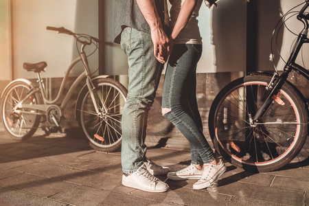 Cropped image of romantic couple in the city with bicycles.の写真素材
