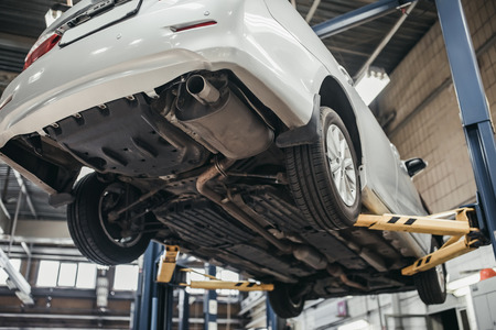 Car raised on car lift in autoservice.の写真素材