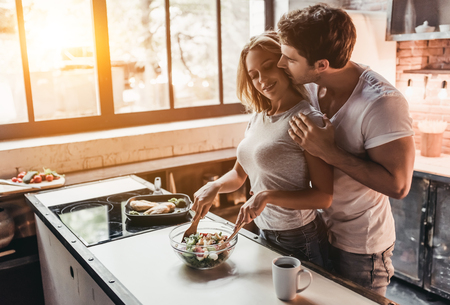 Attractive couple is cooking on kitchen.の写真素材