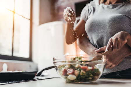 Cropped image of attractive couple is cooking on kitchen.の写真素材