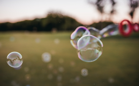 Blowing soap bubbles outdoorsの写真素材