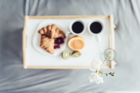 Good morning! Top view of healthy breakfast in bed.の写真素材