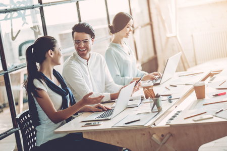 Multiracial young creative people in modern office. Group of young business people are working together with laptop, tablet, smart phone, notebook. Successful hipster team in coworking. Freelancers.の写真素材