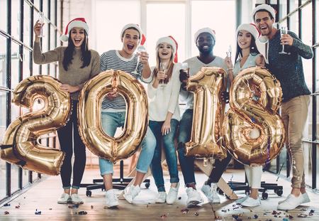 Merry Christmas and Happy New Year 2018!Multiracial young creative people are celebrating holiday in...