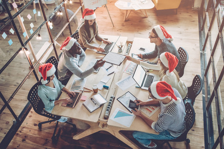 Merry Christmas and Happy New Year 2018!Multiracial young creative people are celebrating holiday in modern office.の写真素材