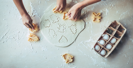Cropped image of attractive young woman and her little cute daughter are cooking on kitchen. Having fun together while making cakes and cookies.の写真素材