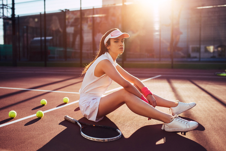 Sport young woman on tennis court. Female tennis player.の写真素材