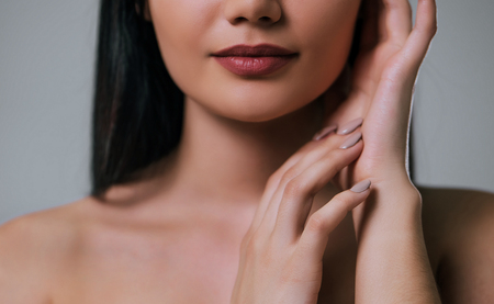 Cropped image of attractive young woman on grey background. Women careの写真素材