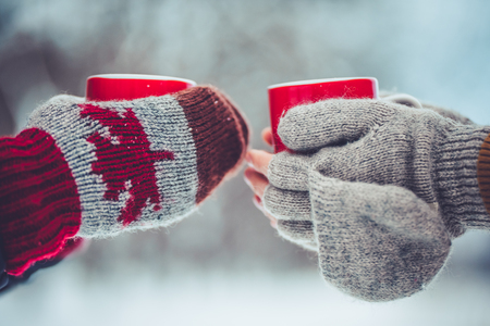 Cropped image of dad and daughter are holding cups and drinking tea outdoor in winter. Enjoying spending time together. Family concept.の写真素材