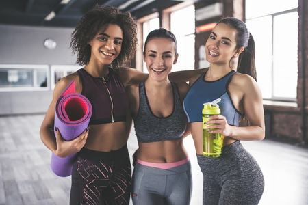 Attractive young sport girls are doing yoga together. Group training. Healthy lifestyle concept.の写真素材