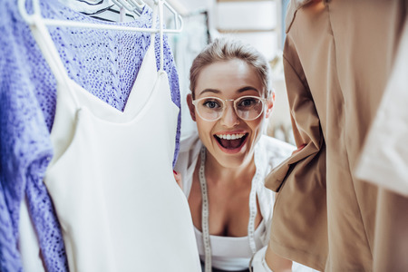 Attractive female fashion designer is working in her workshop. Stylish woman in process of creating new clothes collection.の写真素材