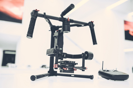Light white store with modern devices. Quadcopters, glasses of virtual reality, camera with stabilization system, 4K video.の写真素材