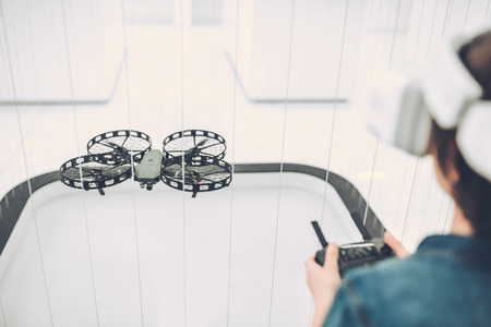 Cute little boy in modern light quadcopter store wearing glasses of virtual reality.の写真素材