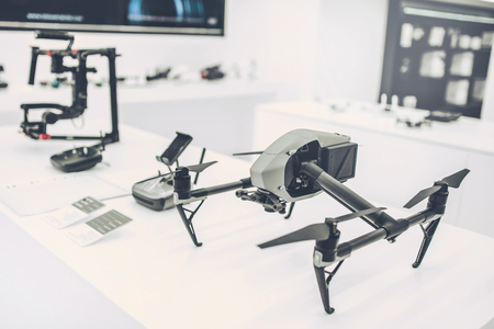 Light white store with modern devices. Quadcopters, glasses of virtual reality, camera with stabilization system, 4K video.の写真素材