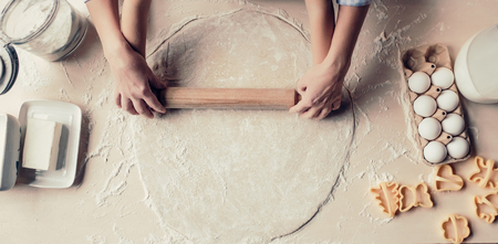 Top view of grandmother and granddaughter are cooking on kitchen. Cropped image of making tasty baking together.の写真素材