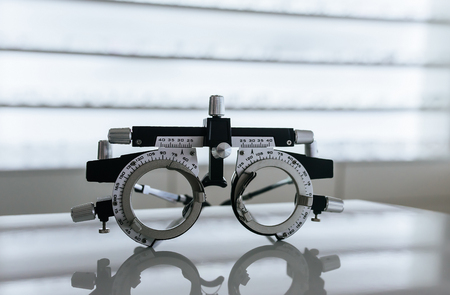 Big choice of eyeglasses on shelves in ophthalmology clinic. Modern light ophthalmology clinic.の写真素材