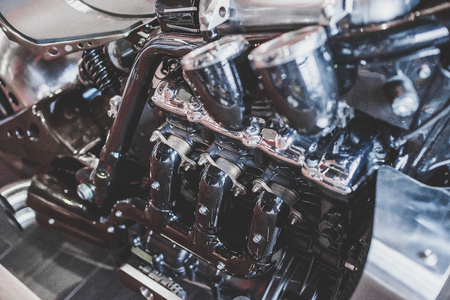 Cropped image of new motorcycle in shop. Motorcycles and accessories in modern motorcycle custom store. Biker stuffの写真素材