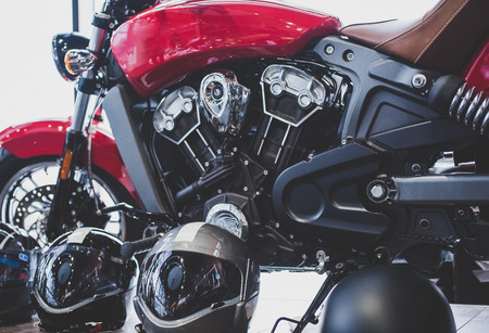 Cropped image of new motorcycle in shop. Motorcycles and accessories in modern motorcycle custom store. Biker stuffの写真素材