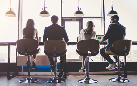 Group of young business people are working together in modern office with laptop, tablet, smart phone, notebook. Successful team in coworking. Freelancers.の写真素材