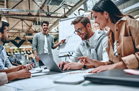 Group of young multiracial business people are working in modern office. Freelancers in coworking place. Creative and stylish youth.の写真素材