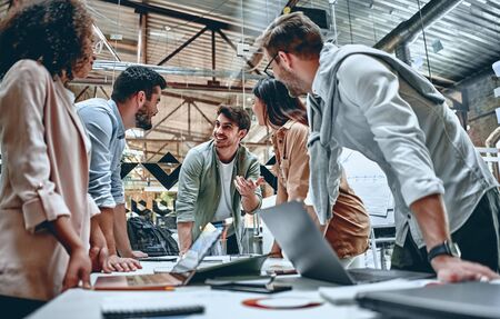 Group of young multiracial business people are working in modern office. Freelancers in coworking place. Creative and stylish youth.の写真素材